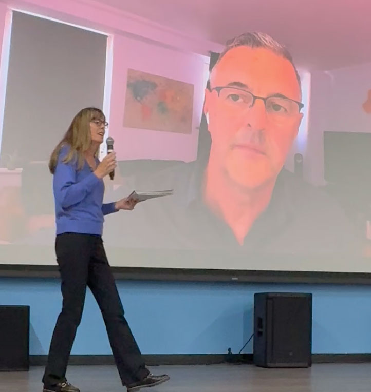 Heidi on stage with Dave on screen